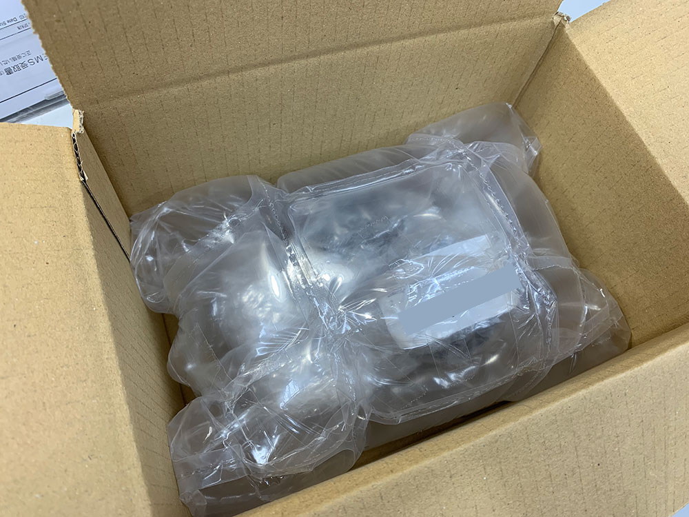 Camera packed in a box surrounded by inflated air cushions
